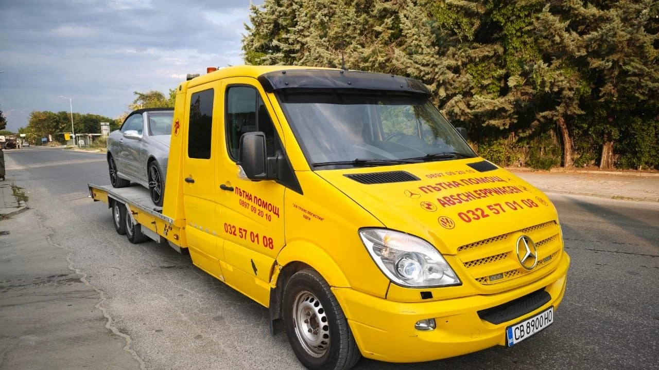 AM Trans Logistics tow truck with vehicle